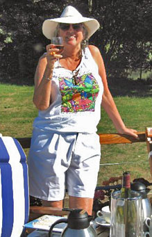Woman on a canal boat holding a glass of wine