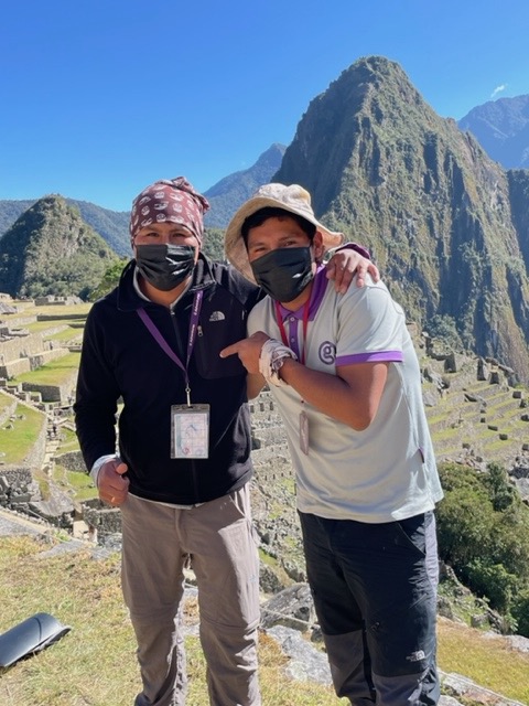2 Inca Trail guides with mountains and blue sky behind