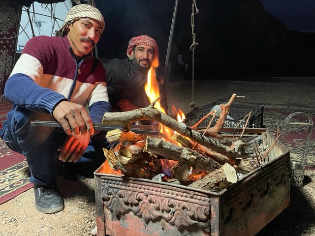 2 men by a camp fire