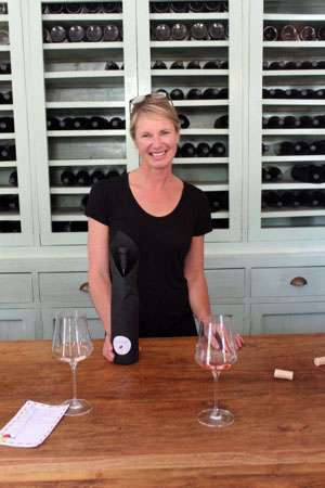 Woman serving at a wine tasting in New Zealand