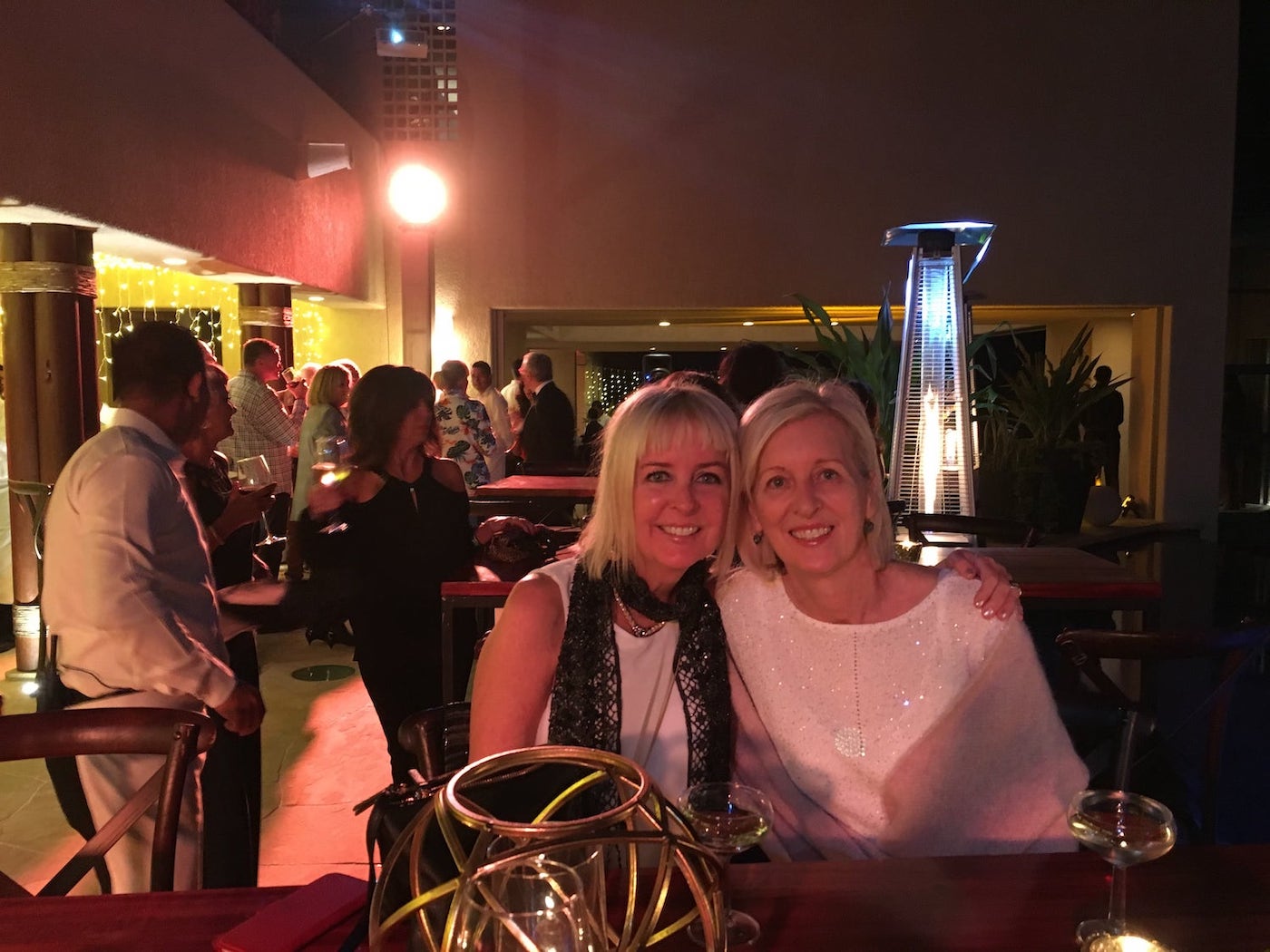 Two blonde ladies at an evening event