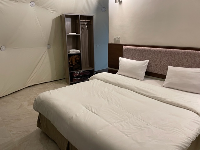 bed and wardrobe in a luxury camp room