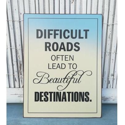 difficult roads lead to beautiful destinations quote - leaning against a wooden fence