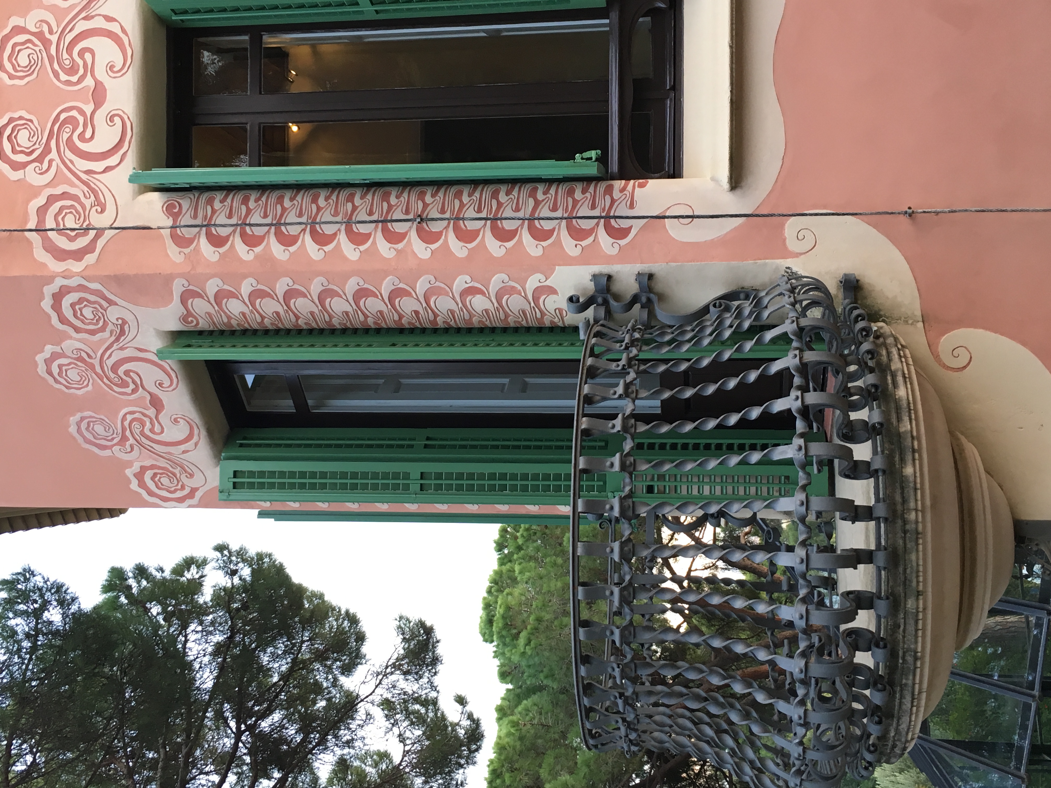 Whimsical pink house with detailed balcony