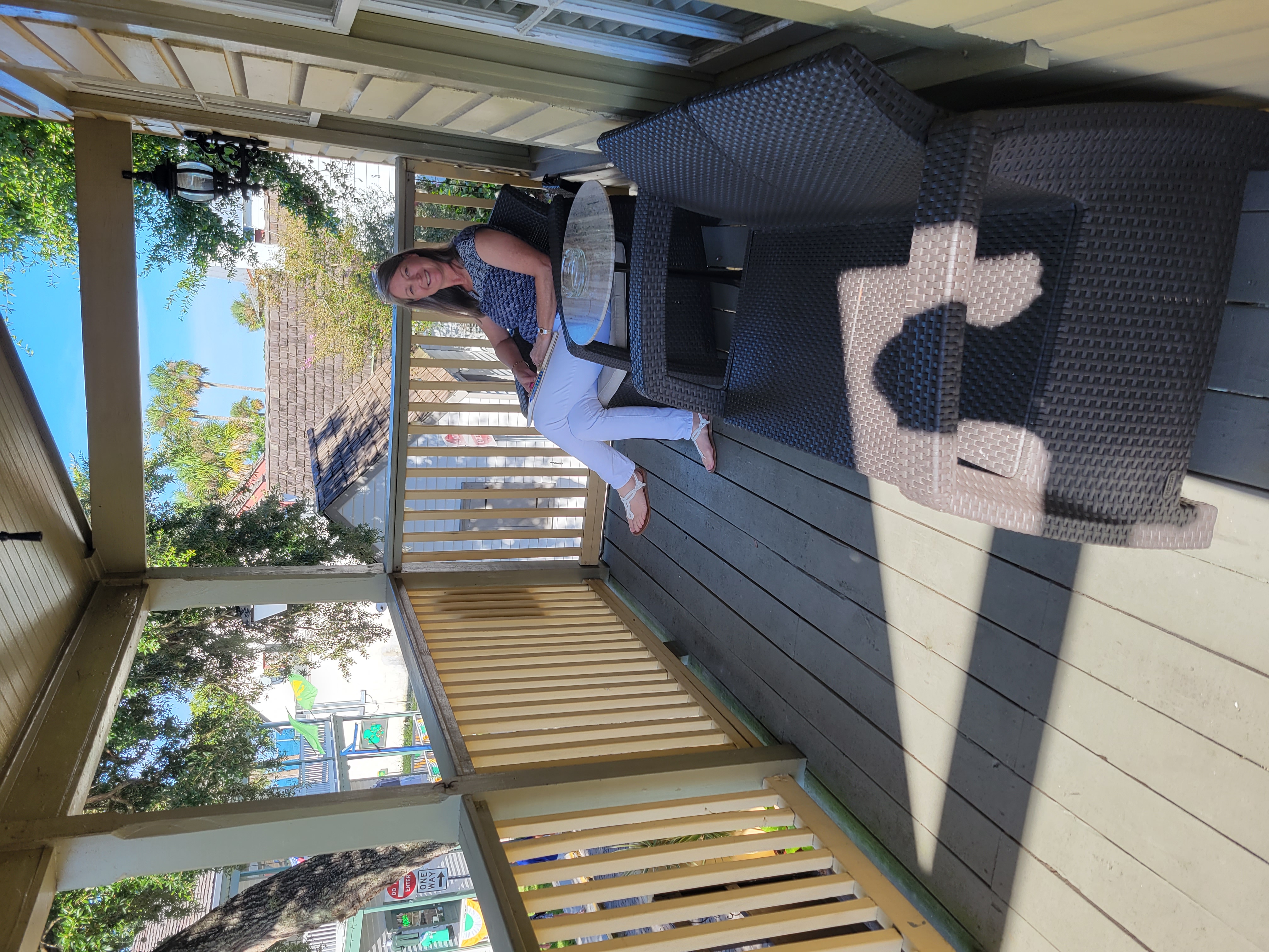 lady sitting on a chair on a timber balcony