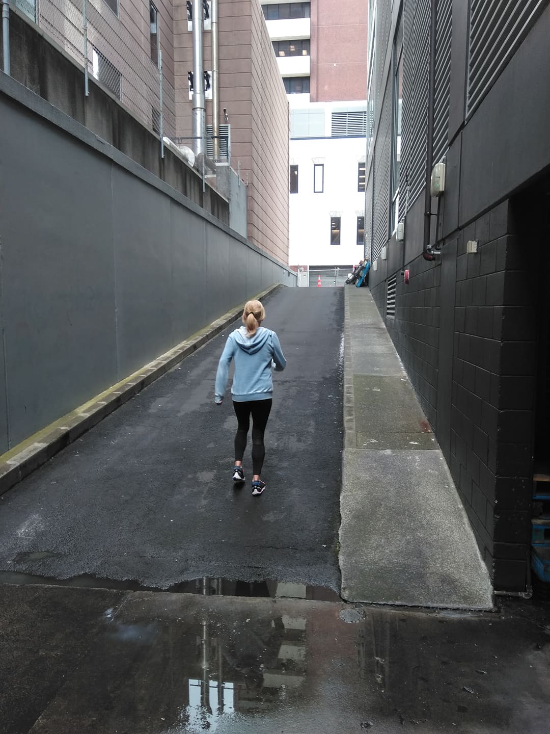 lady in blue top walking up a ramp