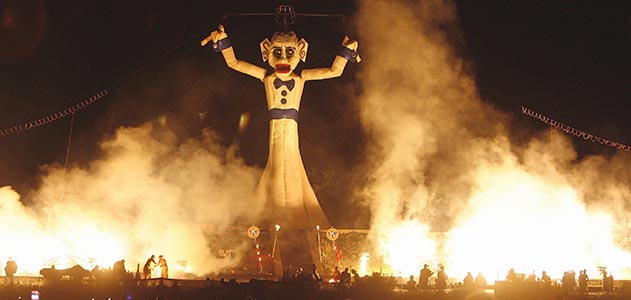 Huge Zozobra effigy burning at night