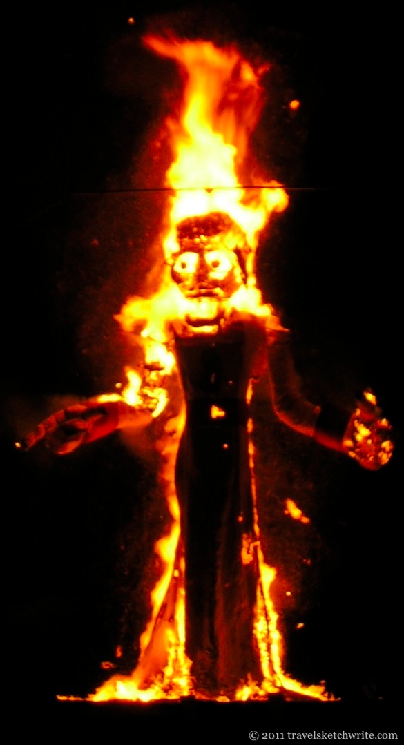 Night-time image of Zozobra burning in flames