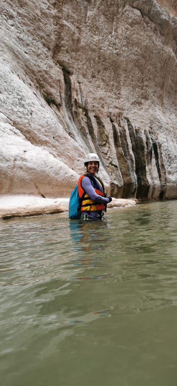 lady hiking through water