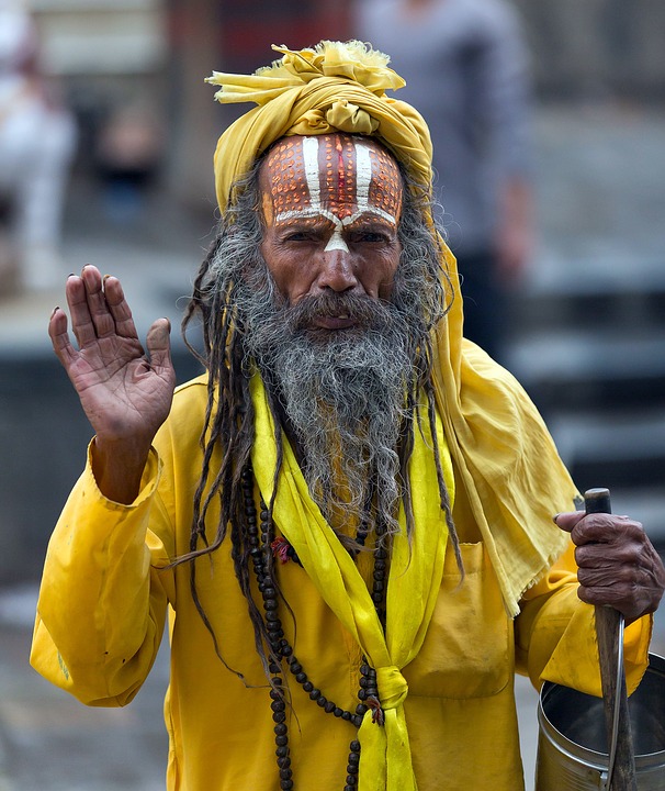An Indian man in yellow clothing.