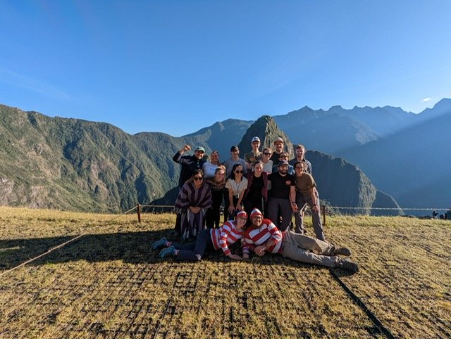 Group of people with mountains and blue sky