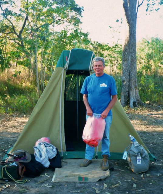 Man standing in front of a small tent in Kakadu National Park, Australia