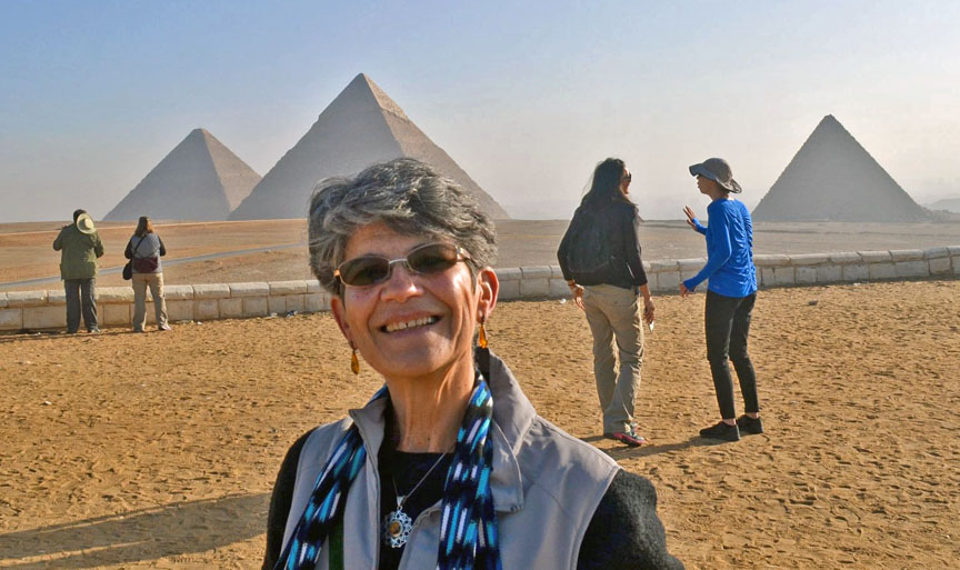 Woman standing in front of the Pyramids, Cairo, Egypt