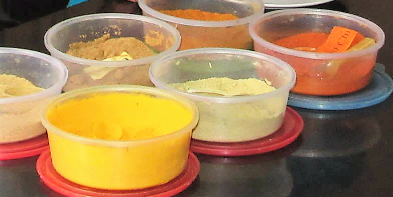 Plastic tubs with colorful cooking ingredients in them