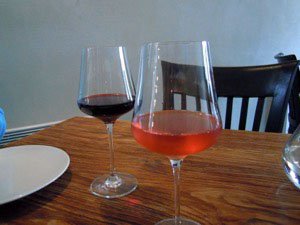 Glasses of red and rosé wine on a table
