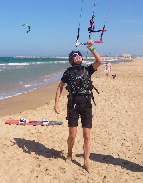 Man on beach preparing for kite surfing