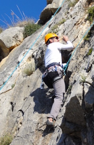 Man rock climbing on a sunny day